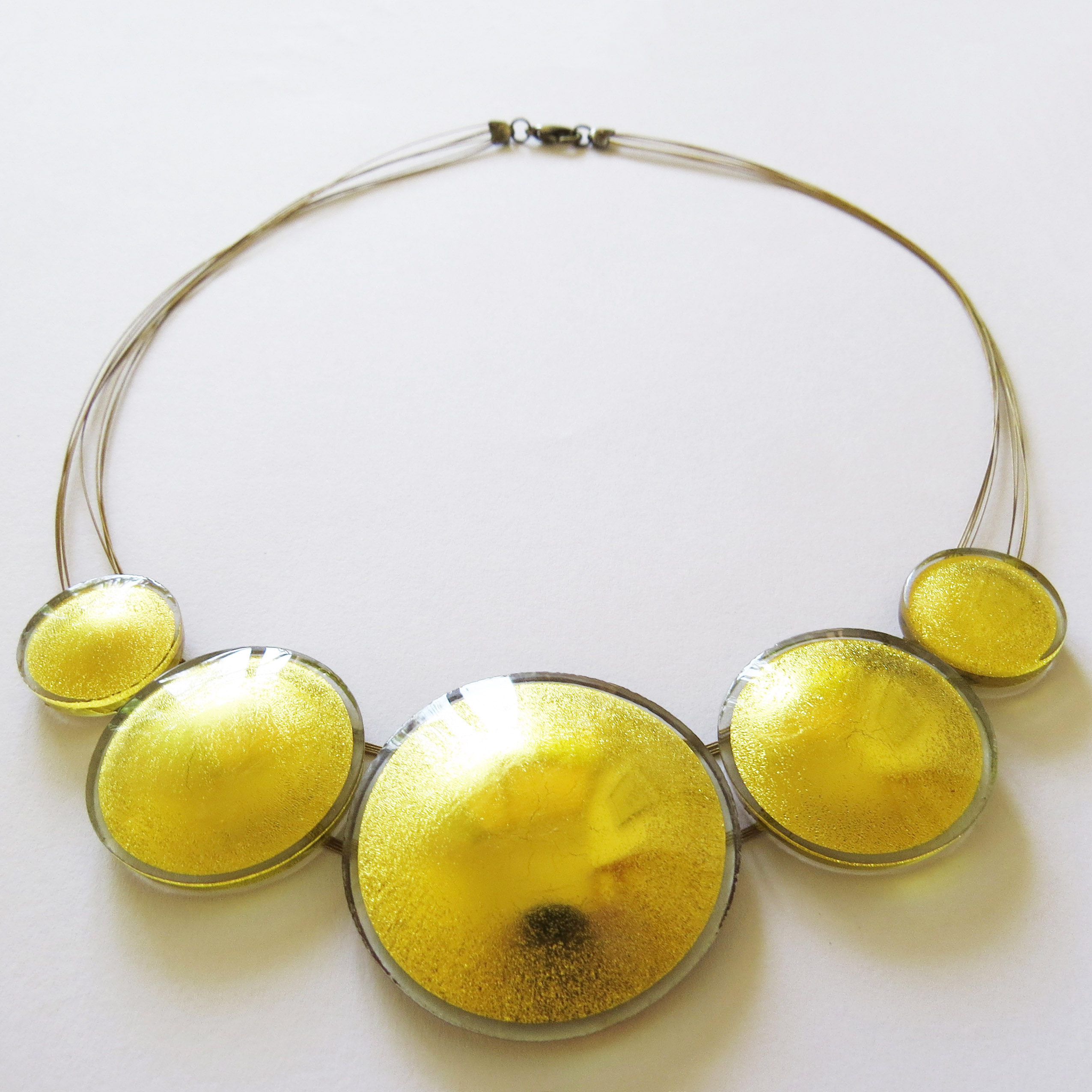 Sun necklace (SN5), made of five suns in 2, 3 and 4 cm, 45 cm circumference, which can get prolonged on request.