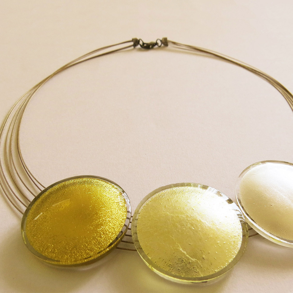 Detail, 24 Karat gold in Glass, yellow glass on silver, silver in glass
