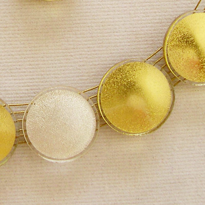 Sun necklace (SN72), detail showing 24 karat gold-in-glass pieces and 1 white gold-in-glass piece.