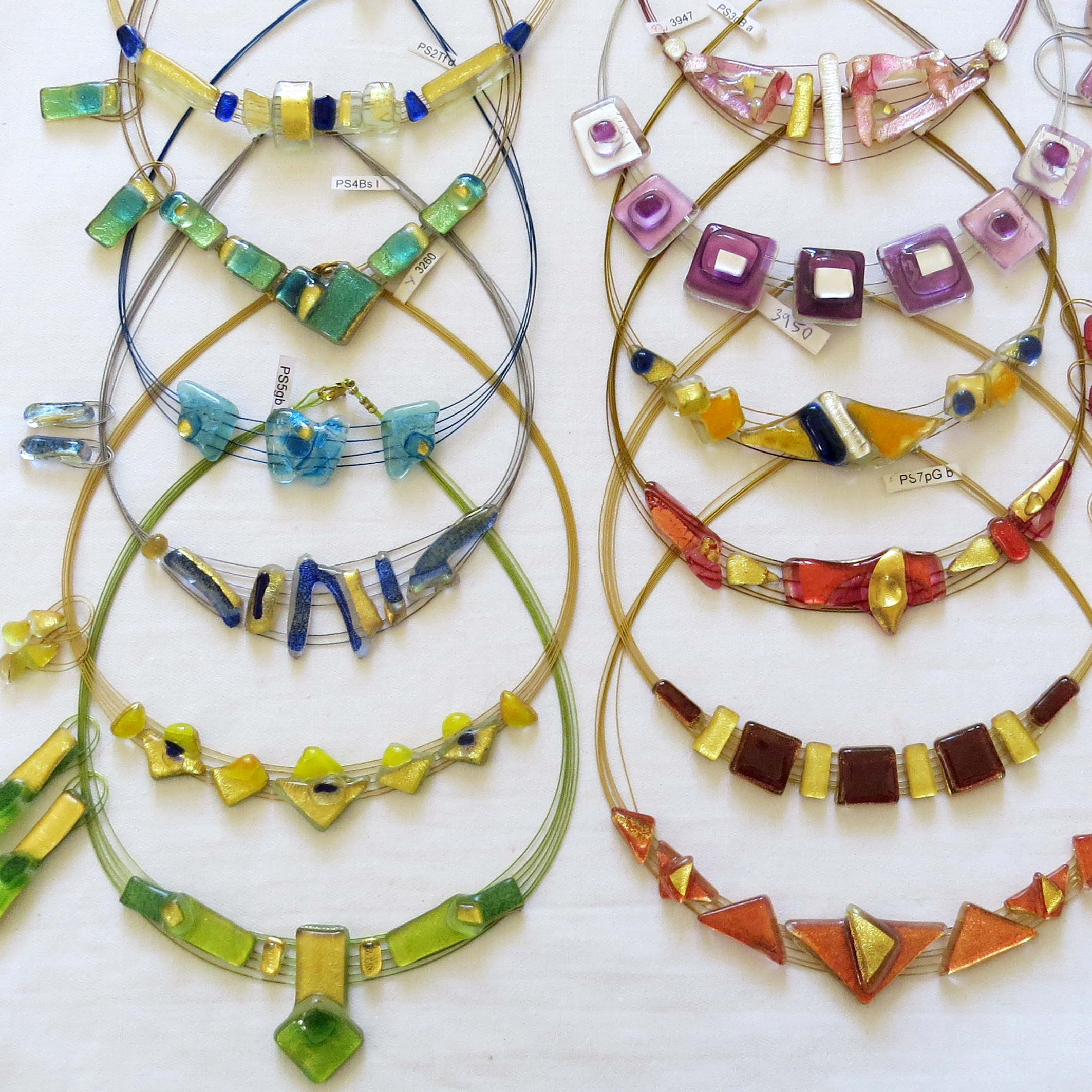 Various Colour Creation sets, single pieces necklaces with earrings (on the side). We have a large variety to select from in many colours and styles.