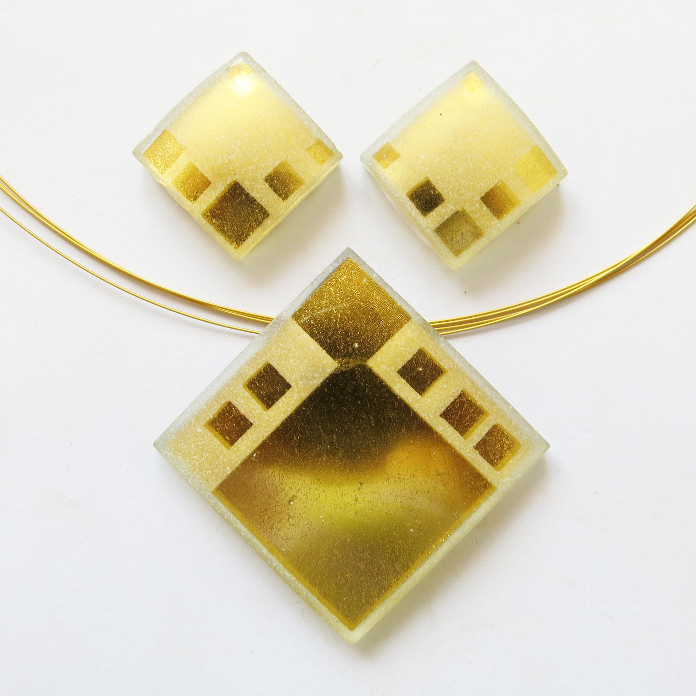 Square pendant (4 cm) and earrings (2 cm), sandblasted single pieces, available in different designsWe still have some Squares on stock in larger sizes and also a small range of silver-in-glass and white gold-in-glass single pieces. As they are all made by hand, they come always different.